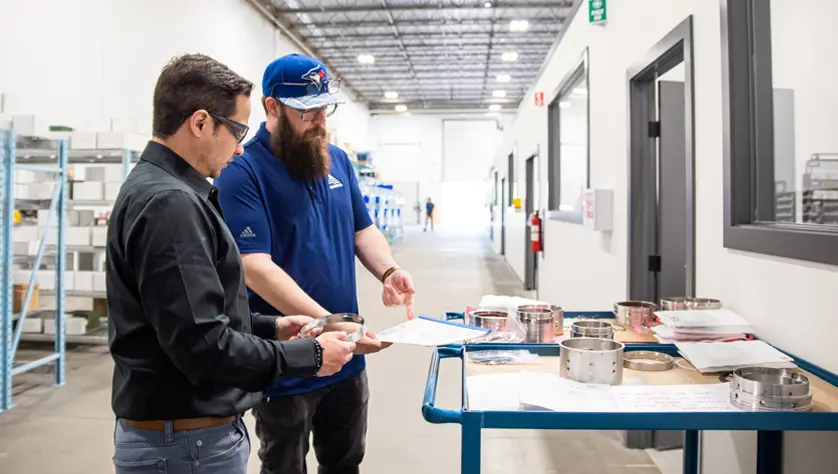 Two AESSEAL employees discuss seal parts.