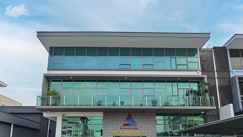Staff pose for photo in front of AESSEAL East Asian Regional HQ entrance in Selangor.