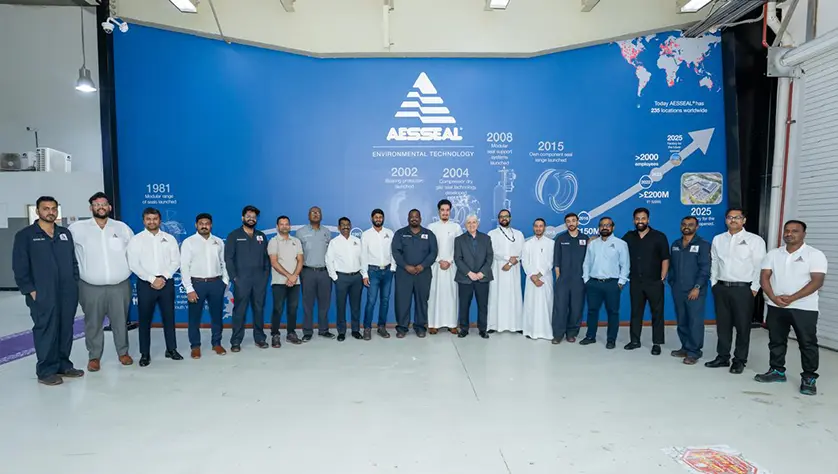 Staff pose for photo with managing director Chris Rea in Saudi Arabia.