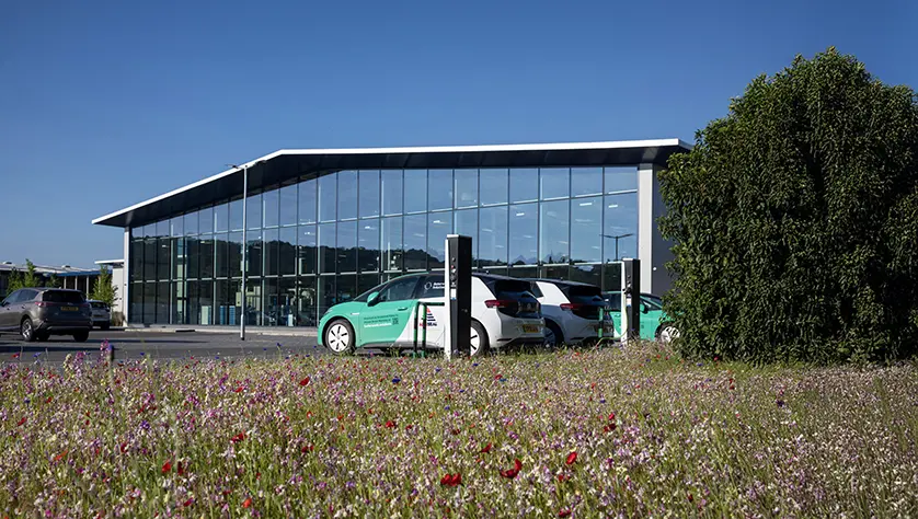 Wildflowers in front of AESSEAL electric vehicle at Rotherham headquarters.