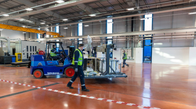 NTX machine on fork lift through the factory