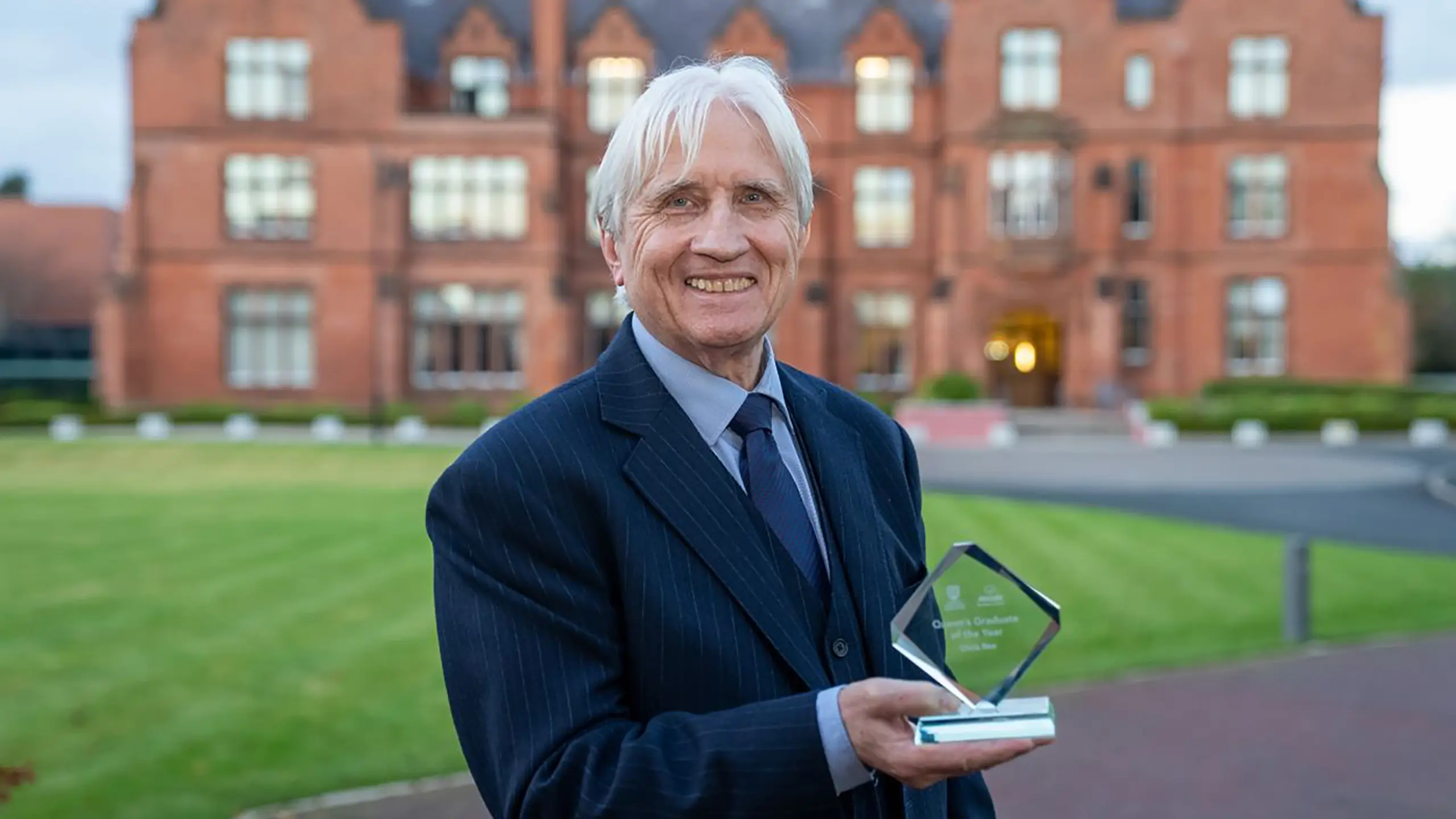 Chris Rea accepts award at Queen's University Belfast.