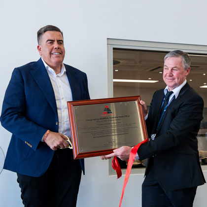 Two men with presentation plaque.