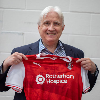 Chris Rea holding RUFC Shirt with Rotherham Hospice Sponsorship